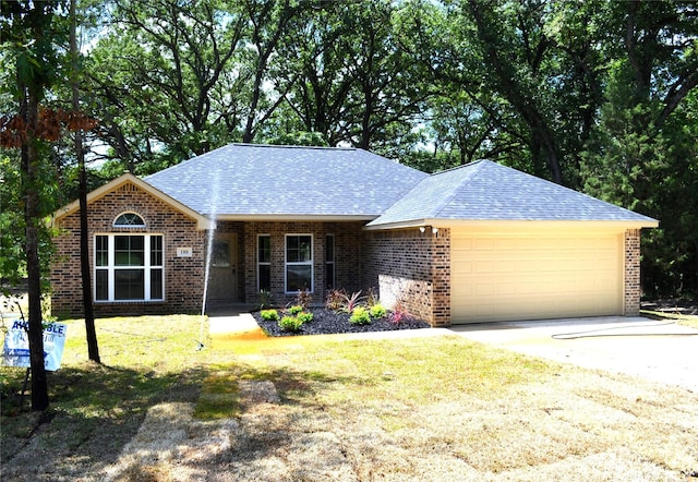 ranch-style home with a front yard and a garage