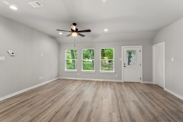 unfurnished living room with light hardwood / wood-style floors, vaulted ceiling, and ceiling fan