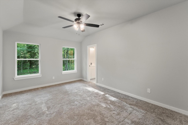 carpeted empty room featuring ceiling fan and lofted ceiling