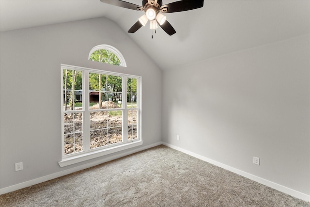 carpeted empty room featuring ceiling fan and lofted ceiling