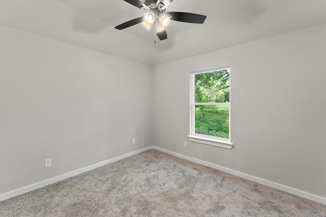 empty room featuring light colored carpet and ceiling fan