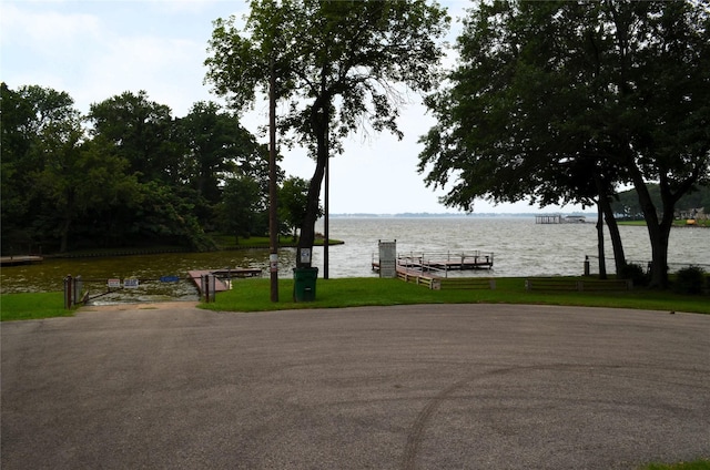 exterior space featuring a boat dock and a water view