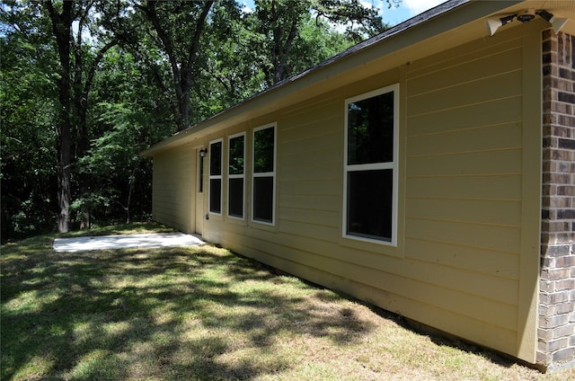 view of side of property with a yard