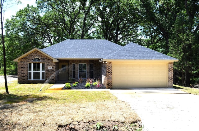 ranch-style house with a garage and a front lawn