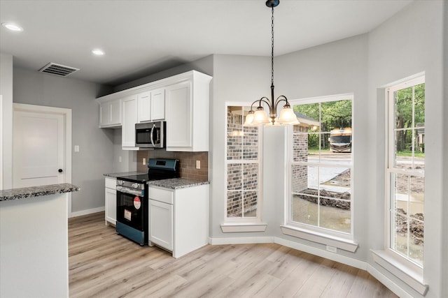 kitchen featuring appliances with stainless steel finishes, backsplash, pendant lighting, light hardwood / wood-style flooring, and white cabinetry