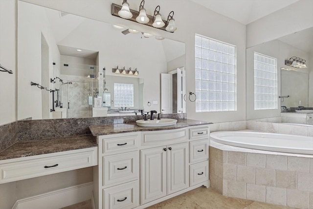 bathroom with vanity, plenty of natural light, plus walk in shower, and tile patterned flooring