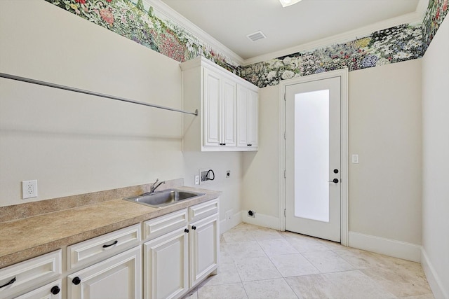 clothes washing area featuring cabinets, washer hookup, electric dryer hookup, crown molding, and sink