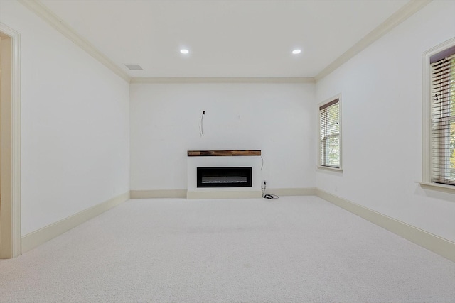 unfurnished living room featuring carpet and ornamental molding