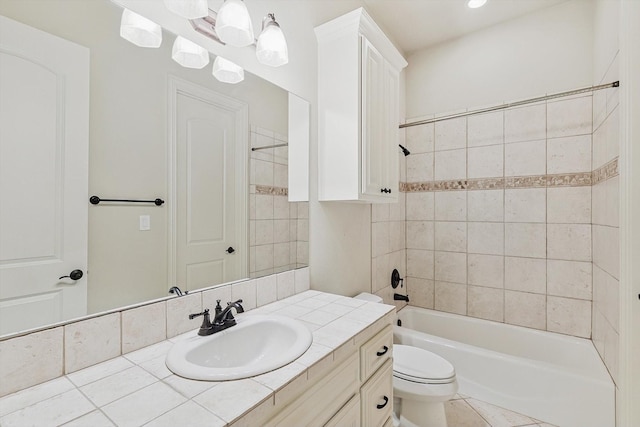 full bathroom featuring vanity, tiled shower / bath combo, toilet, and tile patterned flooring