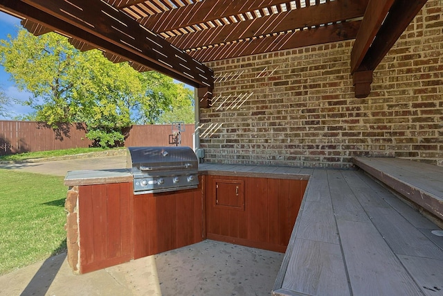 view of patio / terrace featuring an outdoor kitchen, area for grilling, and a pergola