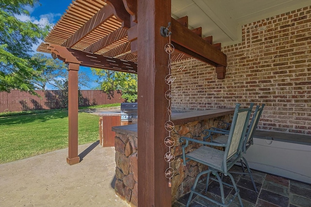 view of patio / terrace featuring a pergola, an outdoor bar, and grilling area