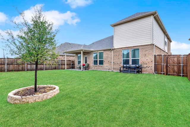 back of property featuring a yard and a patio