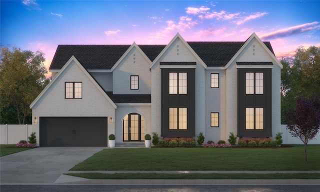 view of front of property featuring a garage and a yard