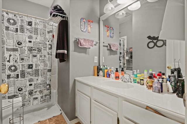 bathroom with tile patterned floors, vanity, and shower / bathtub combination with curtain