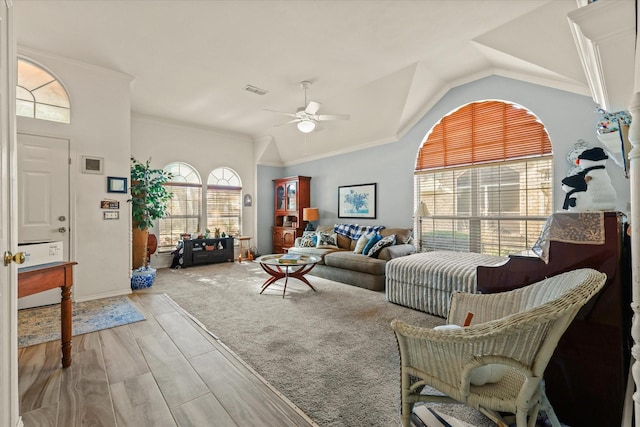 living room featuring ceiling fan, lofted ceiling, and ornamental molding