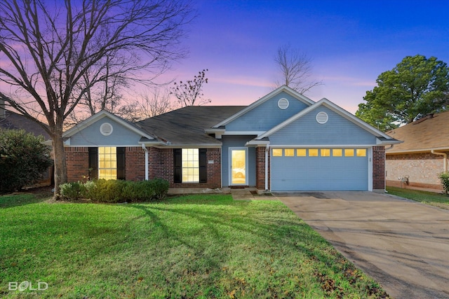 single story home featuring a garage and a yard