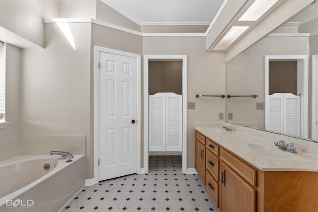 bathroom with ornamental molding, vanity, and a bathing tub