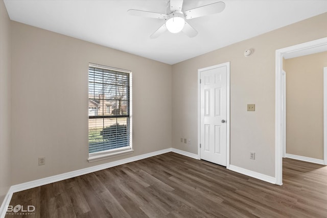 unfurnished room featuring dark hardwood / wood-style flooring and ceiling fan