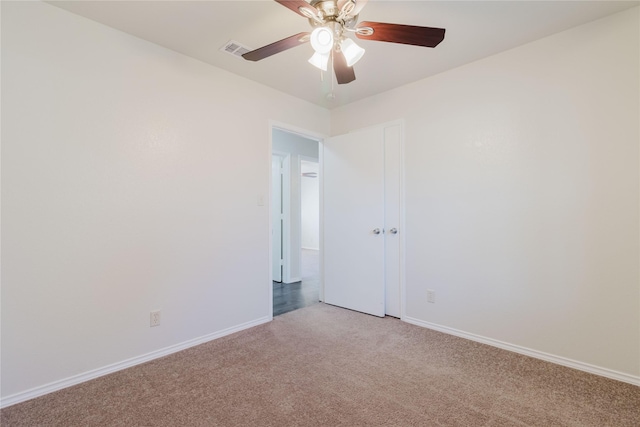 unfurnished room featuring light colored carpet and ceiling fan