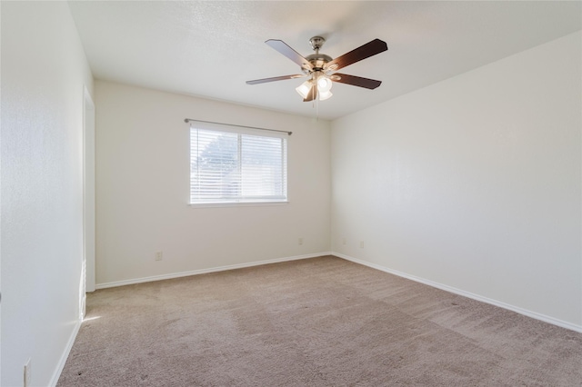 empty room with light colored carpet and ceiling fan