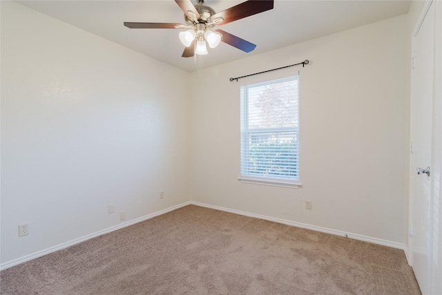 spare room featuring ceiling fan and light carpet