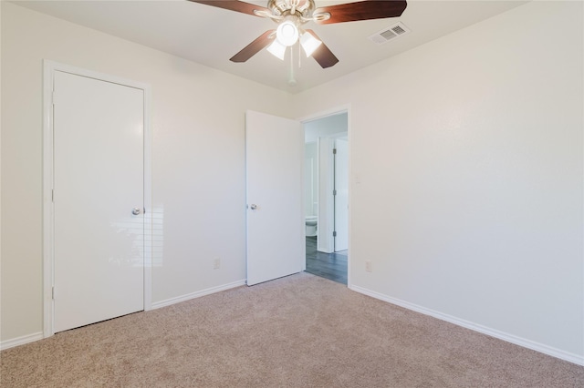 unfurnished bedroom with ceiling fan and light colored carpet