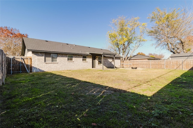 rear view of property featuring a lawn