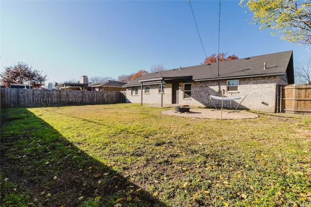 rear view of property featuring a yard