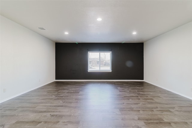 unfurnished room with light hardwood / wood-style flooring