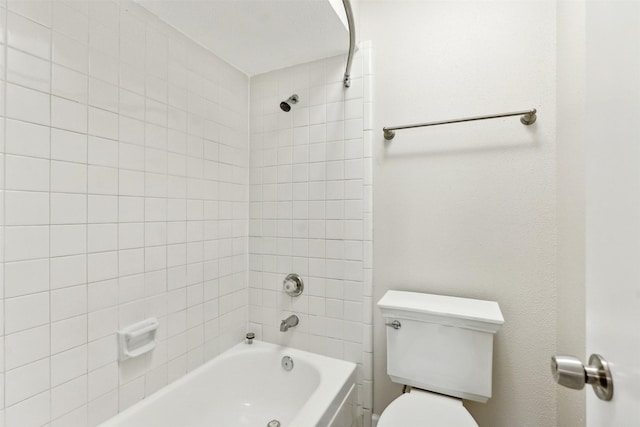 bathroom featuring tiled shower / bath and toilet