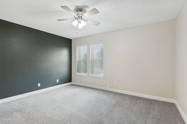 carpeted spare room with ceiling fan and a textured ceiling