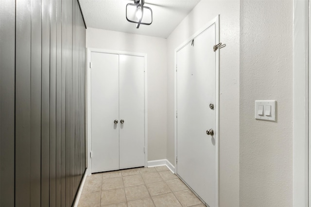 entryway with light tile patterned flooring