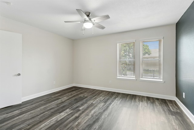 spare room featuring ceiling fan and dark wood-type flooring