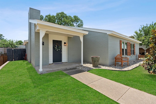 ranch-style house featuring a porch and a front lawn