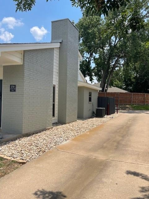 view of side of property with cooling unit