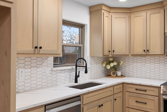 kitchen featuring tasteful backsplash, sink, stainless steel dishwasher, light stone counters, and light brown cabinets