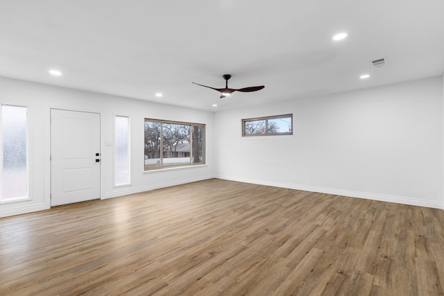 unfurnished living room featuring light hardwood / wood-style flooring and ceiling fan