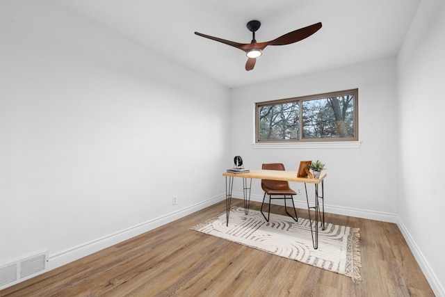 home office with hardwood / wood-style floors and ceiling fan