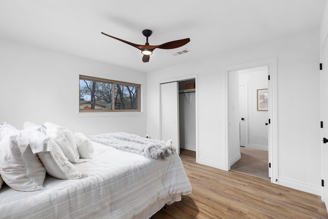 bedroom featuring a closet, ceiling fan, and light hardwood / wood-style flooring