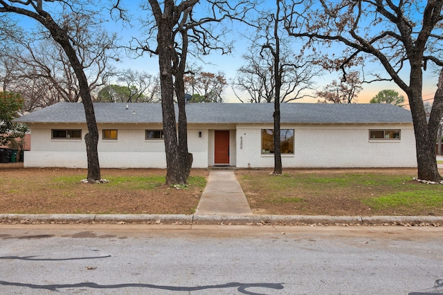 ranch-style home featuring a yard