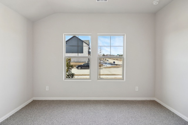 empty room with vaulted ceiling and carpet