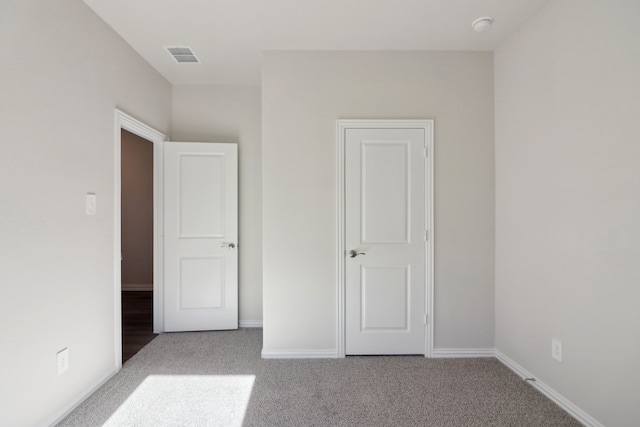 unfurnished bedroom with light colored carpet