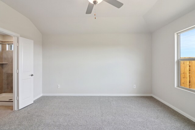 unfurnished bedroom featuring lofted ceiling, light colored carpet, and ceiling fan