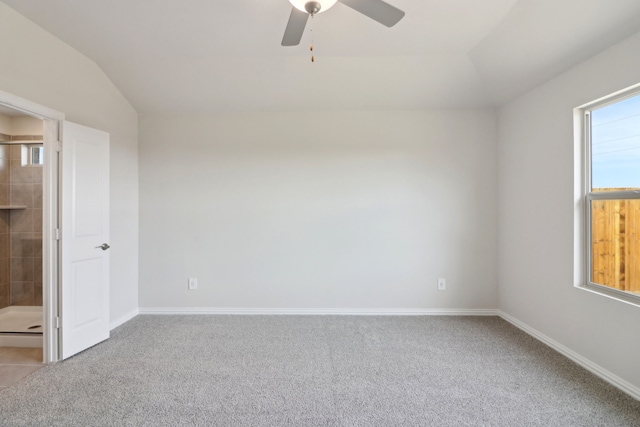 carpeted spare room featuring lofted ceiling and ceiling fan