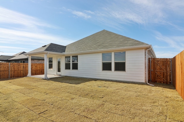 rear view of house featuring a patio and a lawn