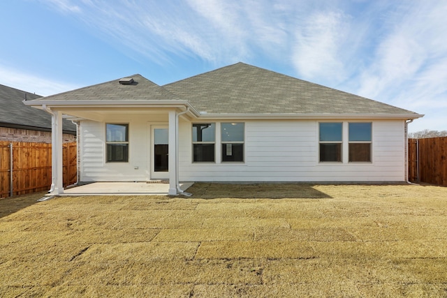 rear view of house with a yard and a patio