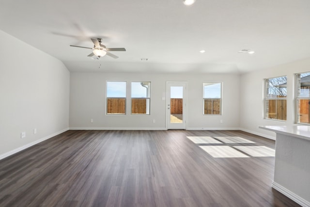 unfurnished living room featuring ceiling fan and dark hardwood / wood-style floors