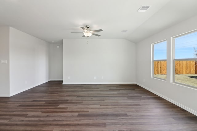 empty room with ceiling fan, dark hardwood / wood-style floors, and lofted ceiling