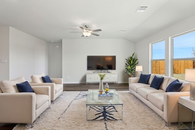 living room with light hardwood / wood-style flooring, ceiling fan, and vaulted ceiling