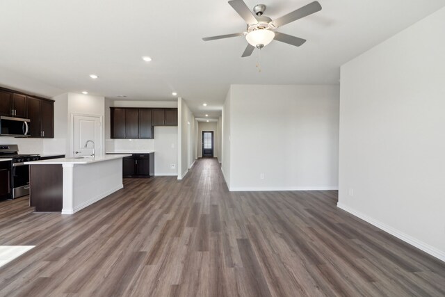 living room featuring light hardwood / wood-style flooring, ceiling fan, and vaulted ceiling